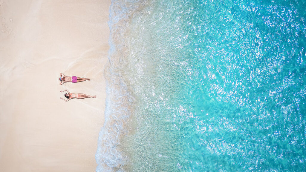 Couple Lounging On Grace Bay Beach